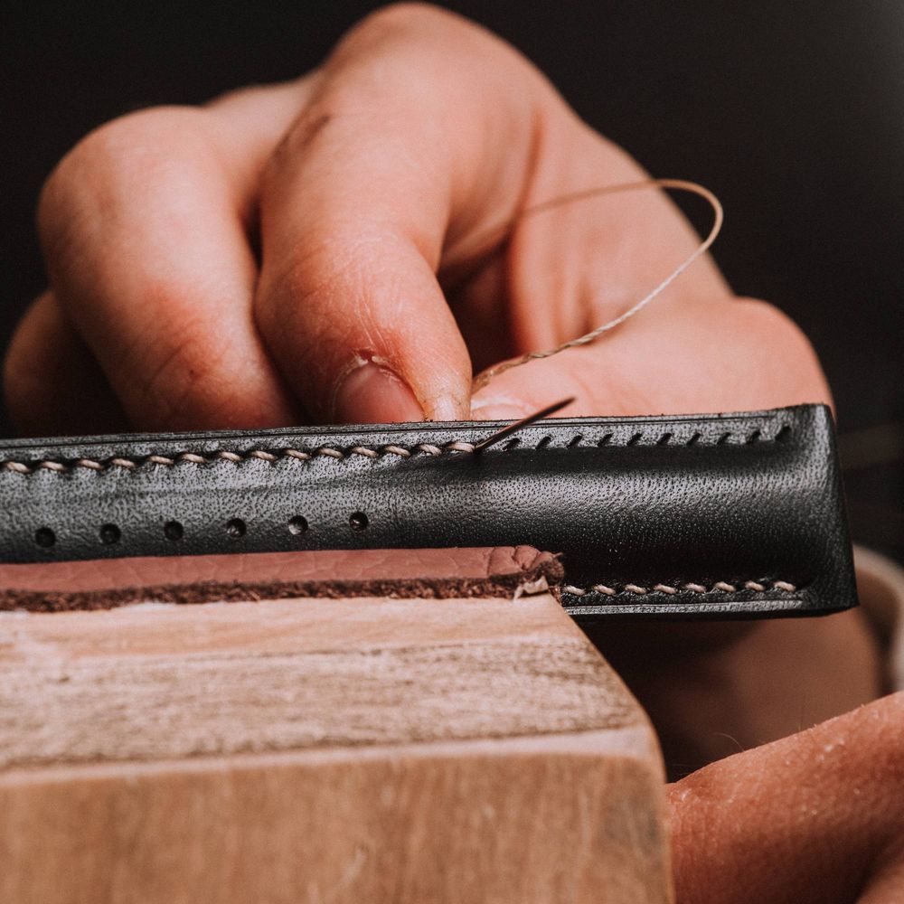 Hand saddle stitching a leather strap